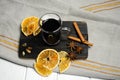 A glass of mulled wine on a wooden board with cinnamon sticks and dried orange slices. Top view Royalty Free Stock Photo