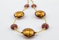 Glass - Murano gold and rose bead necklace close up on white background - Venice