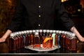 Glass of negroni cocktail with many bottles stands on bar. Royalty Free Stock Photo