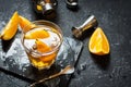 A glass of Negroni cocktail with orange and lemon. Alcoholic drink with rum and vermouth on dark stone table Royalty Free Stock Photo