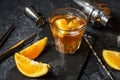 A glass of Negroni cocktail with orange and lemon. Alcoholic drink with rum and vermouth on dark stone table Royalty Free Stock Photo