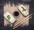 Glass noodles with soy sauce and chopsticks wooden rustic background top view close up