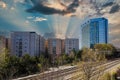 Glass office buildings and apartments along a side a set of railroad tracks with blue sky and powerful clouds in midtown Atlanta Royalty Free Stock Photo