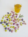 A glass of olive oil and olives