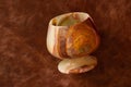 A glass of onyx stone on a colored background close-up