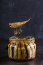 Glass open jar of sprots and fish on a fork Royalty Free Stock Photo