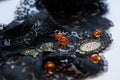 glass orange beads, green small frame with rhinestones and decorative butterfly on black lace Royalty Free Stock Photo