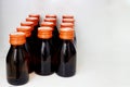 Glass with orange bottles on white background Royalty Free Stock Photo