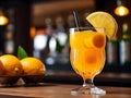 Glass of orange cocktail decorated with lemon at bar counter background Royalty Free Stock Photo