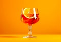 Glass of orange cocktail decorated with orange on yellow background. AI Generated Royalty Free Stock Photo