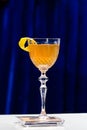 Glass with orange cocktail with slice of orange on bar counter, Royalty Free Stock Photo