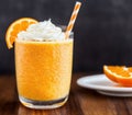 Glass of orange creamsicle smoothie with whipped cream, orange slices, and a straw, garnished with a slice of orange. AI Royalty Free Stock Photo