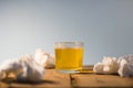 A glass with orange effervescent medicine