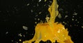 Glass of Orange Exploding against Black Background Royalty Free Stock Photo
