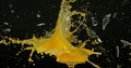 Glass of Orange Exploding against Black Background Royalty Free Stock Photo
