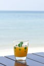 Glass of orange juice at the beach