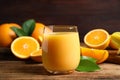 Glass of orange juice and fresh fruits on wooden table Royalty Free Stock Photo
