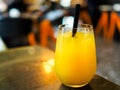 Glass of orange juice / fruit juice in a bar / restaurant setting with copy space