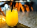 Glass of orange juice / fruit juice in a bar / restaurant setting with copy space