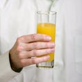 Glass with orange juice in a hand Royalty Free Stock Photo