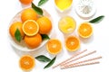 Glass of orange juice with ice cubes and oranges isolated on white background top view. Royalty Free Stock Photo