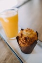 A glass of orange juice with a muffin Royalty Free Stock Photo