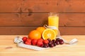 Glass of orange juice, oranges, strawberry, cherry and measuring tape. Selective focus. Healthy eating and dieting concept Royalty Free Stock Photo