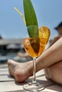 A glass of orange juice and a piece of lemon on the beach Royalty Free Stock Photo