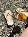 A glass of orange juice and a piece of lemon on the beach Royalty Free Stock Photo