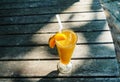 a glass of orange juice on the sandy beach. Fresh orange juice, fruits on sand with wooden background, summer concept Royalty Free Stock Photo