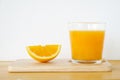 Glass of orange juice with sliced orange on wooden table Royalty Free Stock Photo