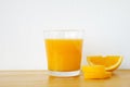 Glass of orange juice with sliced orange on wooden table Royalty Free Stock Photo