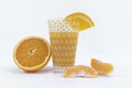 A glass with orange juice, slices and a half orange on a white background - Citrus and delicious orange snack