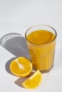 Glass of orange juice with slices orange deep shadows isolated on white background Royalty Free Stock Photo