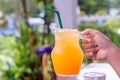 A glass of orange juice in woman hand Royalty Free Stock Photo