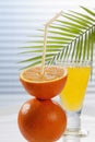 glass of orange lemonade besides oranges on table, close up. Royalty Free Stock Photo