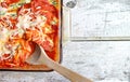 Glass Pan Full Of Cooked Stuffed Shells With Wooden Spoon