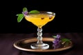 glass of passion fruit martini with a sprig of mint