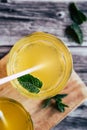 Glass of peach syrup with water and fresh mint - Refreshing drink