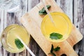 Glass of peach syrup with water and fresh mint - Refreshing drink