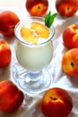 Glass with peach yoghurt Royalty Free Stock Photo