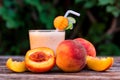 Glass of peach yoghurt and peaches on wooden table Royalty Free Stock Photo