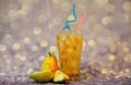 A glass of pear juice with ice and straws stands on a gray shiny background next to ripe fruits Royalty Free Stock Photo