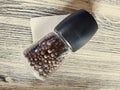 Glass pepper shaker on a wooden table in a cafe Royalty Free Stock Photo