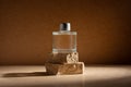 Glass perfume bottle or home fragrance on natural stone podium Royalty Free Stock Photo