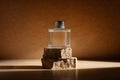 Glass perfume bottle or home fragrance on natural stone podium Royalty Free Stock Photo