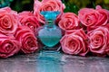 Glass perfume bottle smoke studio water drops flowers Royalty Free Stock Photo