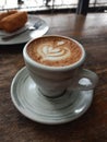 a glass of piccolo latte coffee that is beautifully presented