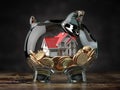 Glass piggy bank with coins and house. Mortgage, savings for real estate or to buy a house concept Royalty Free Stock Photo