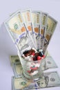 Glass with pills and dollars banknotes. Royalty Free Stock Photo